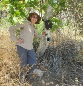 Photo of Shannon standing next to Sycamore tree