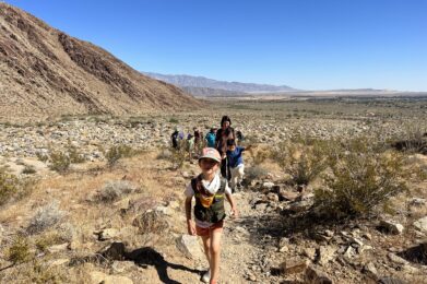 girl leading a class hike in the desert